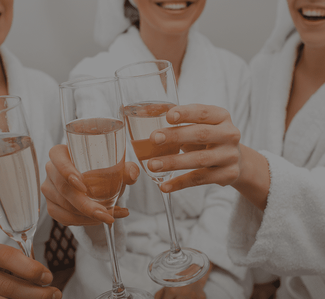 Women toasting with champagne glasses in a celebratory moment.